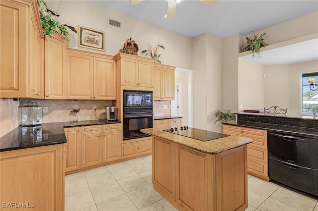 kitchen featuring dark stone countertops, light brown cabinets, light tile patterned floors, and black appliances