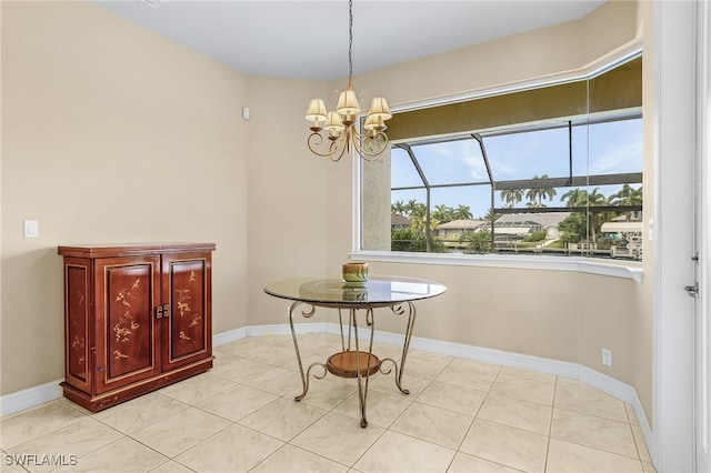 tiled dining room featuring a chandelier