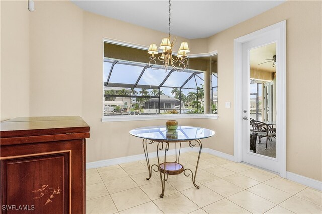 dining area featuring light tile patterned floors and ceiling fan with notable chandelier