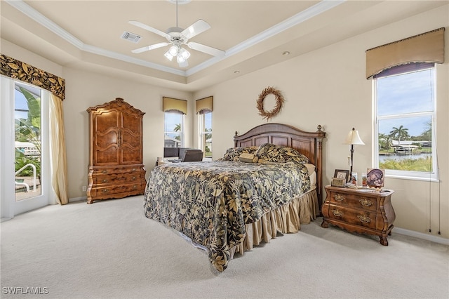 carpeted bedroom with a tray ceiling, ceiling fan, access to outside, and ornamental molding