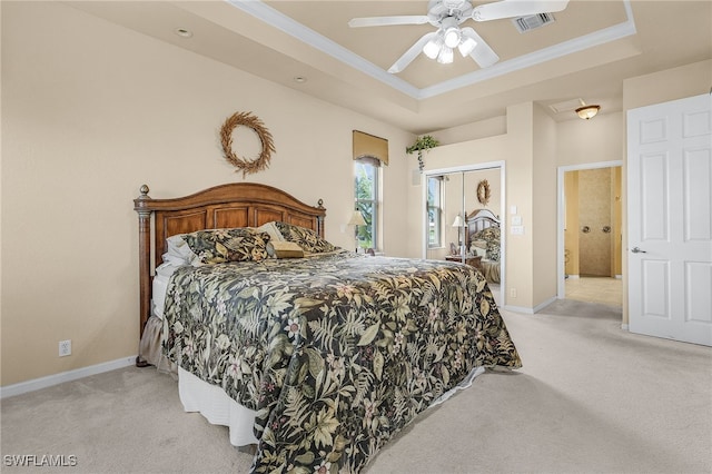 carpeted bedroom featuring a raised ceiling, ceiling fan, and ornamental molding