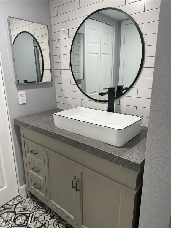 bathroom with vanity, backsplash, and tile patterned floors