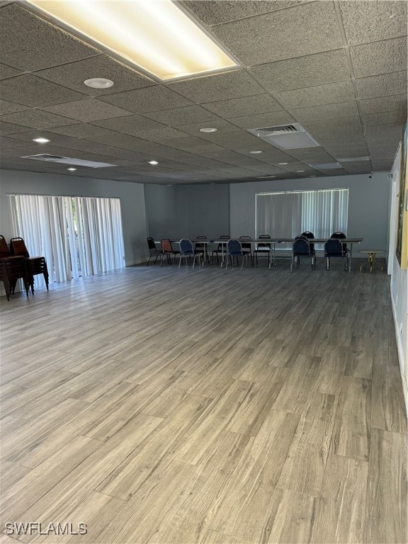 miscellaneous room featuring wood-type flooring and a paneled ceiling