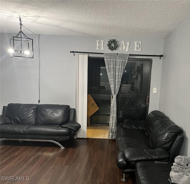 living room featuring a textured ceiling and hardwood / wood-style flooring