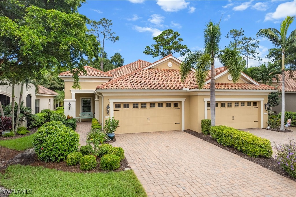 mediterranean / spanish-style house featuring a garage