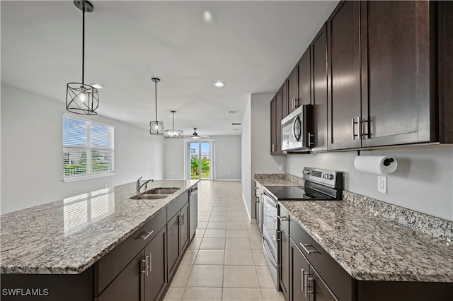 kitchen featuring a kitchen island with sink, stainless steel appliances, and sink