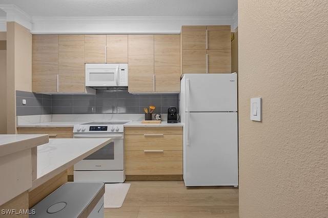 kitchen with light hardwood / wood-style floors, tasteful backsplash, white appliances, crown molding, and light brown cabinetry