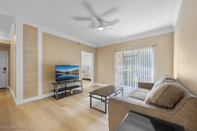 living room with a textured ceiling, light hardwood / wood-style floors, ceiling fan, and crown molding