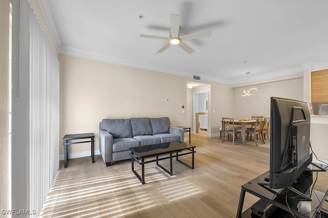 living room with ceiling fan, ornamental molding, and light hardwood / wood-style floors