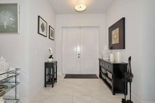 foyer entrance featuring light tile patterned flooring