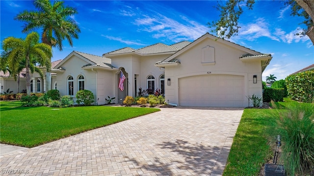 mediterranean / spanish-style house with a front yard and a garage