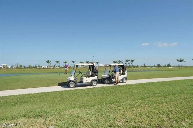 view of property's community featuring a yard and a water view