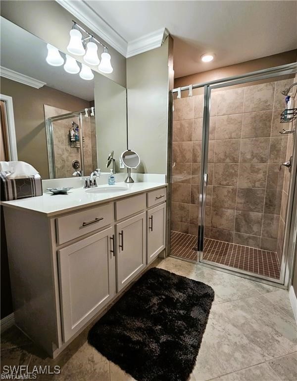 bathroom with walk in shower, ornamental molding, tile patterned flooring, and vanity