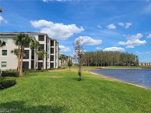 view of home's community featuring a lawn and a water view