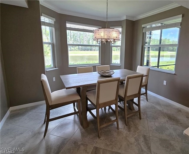 dining space featuring ornamental molding, a water view, and a healthy amount of sunlight