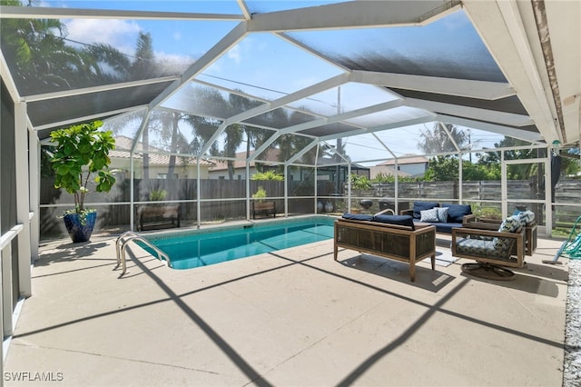 view of swimming pool with a patio, outdoor lounge area, and a lanai