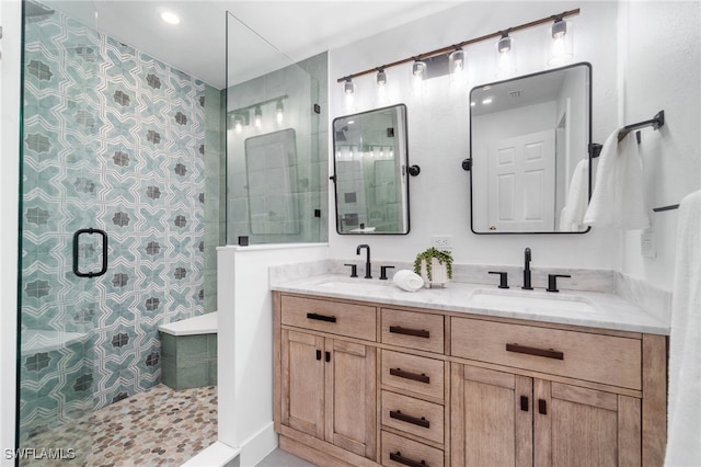 bathroom with vanity and a shower with shower door