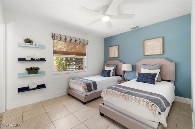 tiled bedroom featuring ceiling fan