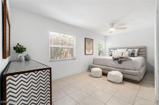 tiled bedroom featuring ceiling fan