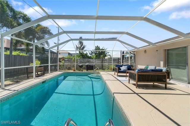 view of swimming pool with a lanai, outdoor lounge area, and a patio