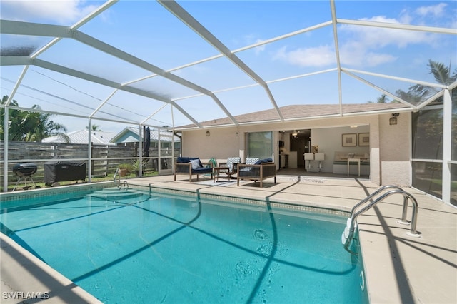 view of swimming pool with outdoor lounge area, glass enclosure, and a patio