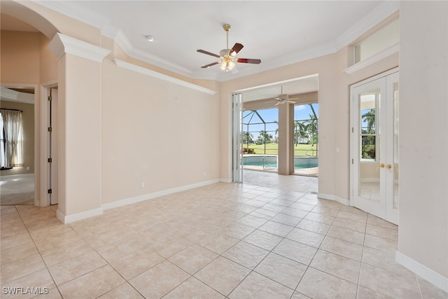 empty room featuring ceiling fan, light tile patterned flooring, crown molding, and french doors