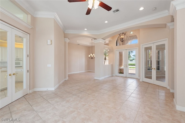 unfurnished room with ceiling fan with notable chandelier, crown molding, light tile patterned floors, and french doors