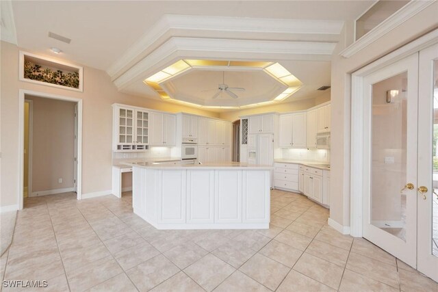 kitchen featuring ceiling fan, white cabinets, white appliances, french doors, and a center island