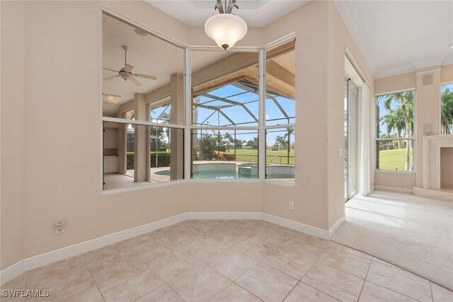 interior space with ceiling fan and crown molding