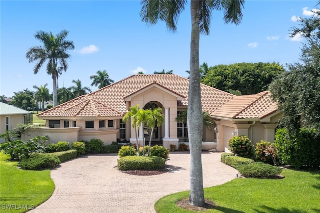 mediterranean / spanish-style home featuring a front yard