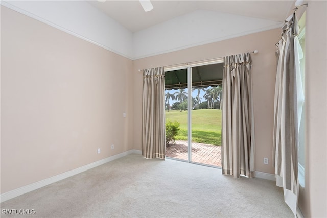 empty room with light colored carpet and vaulted ceiling