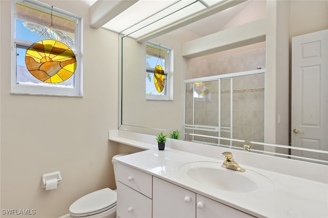 bathroom featuring walk in shower, vanity, and toilet