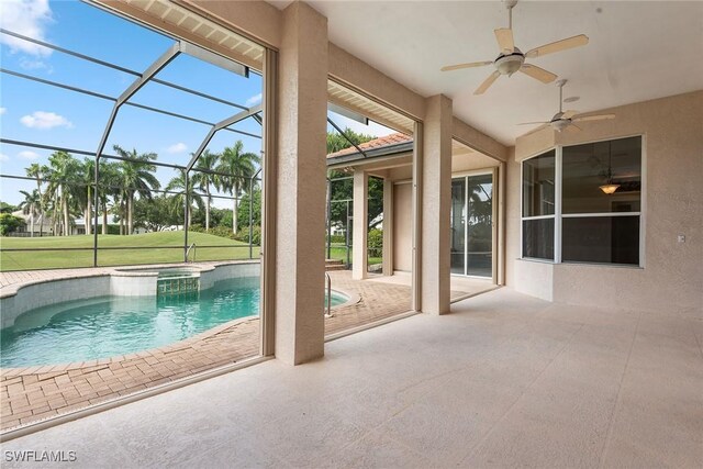 view of pool featuring a patio, an in ground hot tub, a lanai, a lawn, and ceiling fan