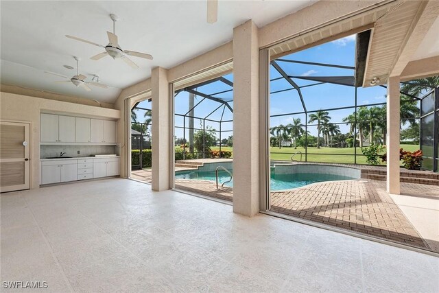 interior space with vaulted ceiling, sink, and ceiling fan