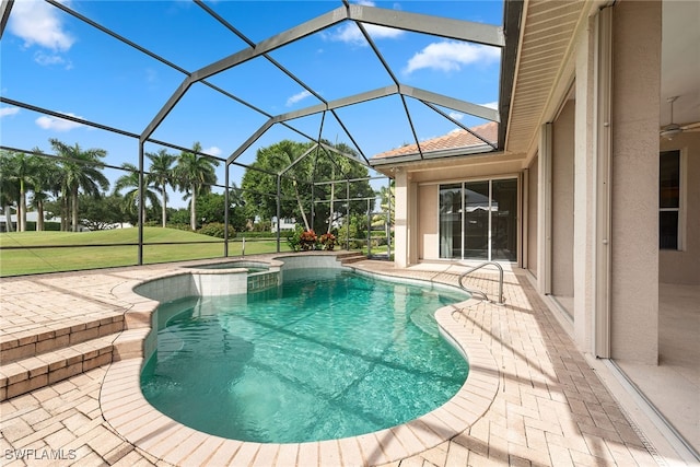 view of swimming pool featuring a patio, an in ground hot tub, and a lanai