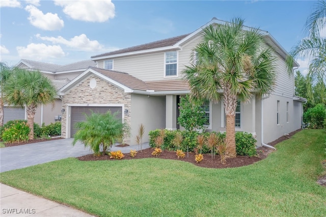 view of front of house featuring a front yard and a garage