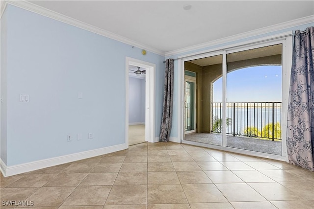 unfurnished room with crown molding, ceiling fan, and light tile patterned flooring