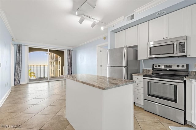 kitchen featuring white cabinetry, ornamental molding, track lighting, and appliances with stainless steel finishes