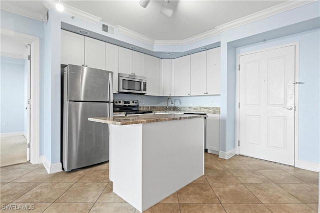 kitchen featuring a kitchen island, white cabinetry, stainless steel appliances, and ornamental molding