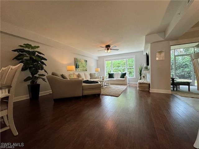 living room with dark hardwood / wood-style flooring and ceiling fan