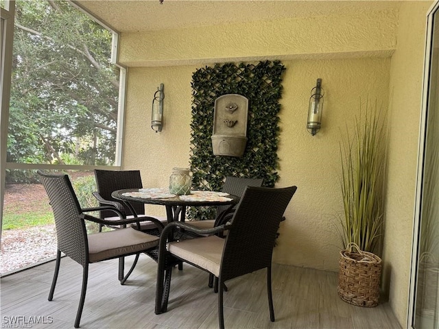 dining space with hardwood / wood-style floors