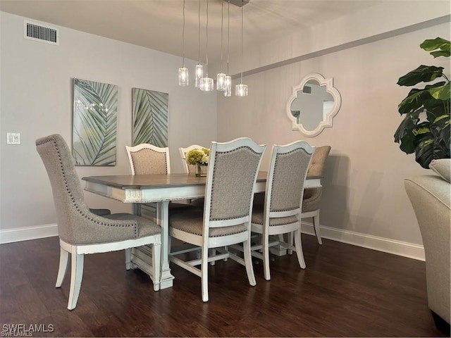 dining space featuring dark wood-type flooring