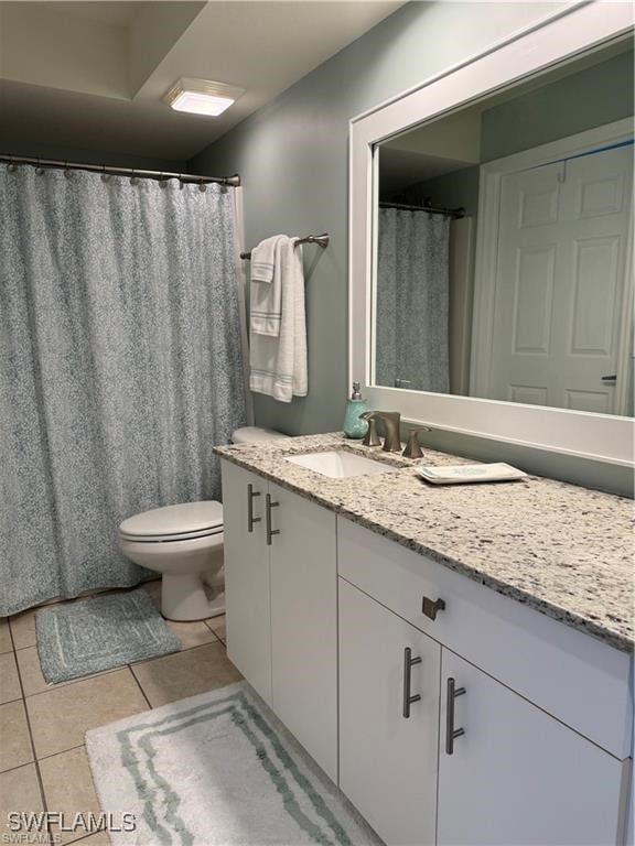 bathroom featuring tile patterned floors, vanity, and toilet