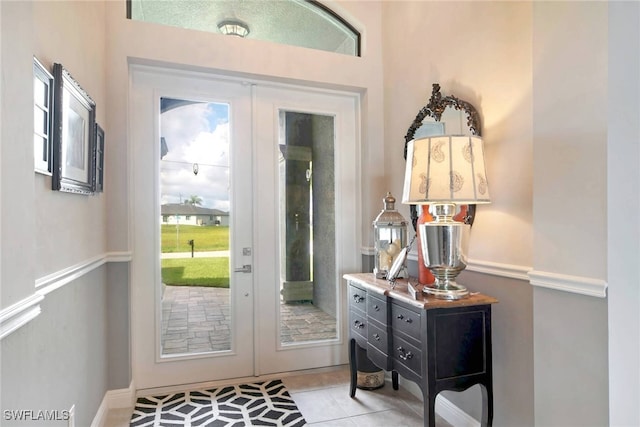 tiled entryway featuring french doors