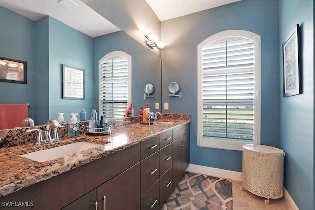 bathroom featuring tile patterned flooring, plenty of natural light, and vanity