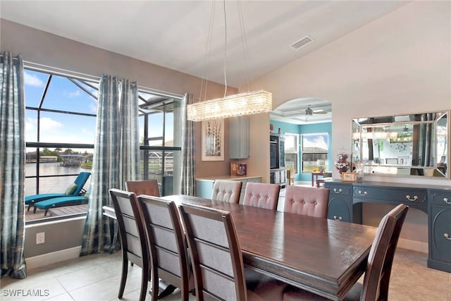 dining room featuring a water view and light tile patterned floors