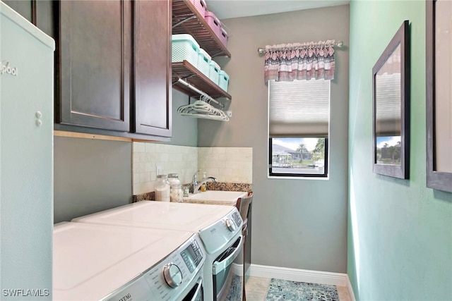 laundry area featuring cabinets, sink, and washing machine and dryer