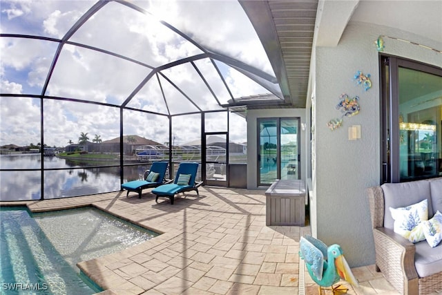 view of swimming pool with outdoor lounge area, a water view, a patio, and a lanai