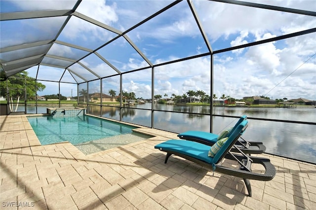 view of swimming pool featuring a lanai, a patio, a water view, and an in ground hot tub