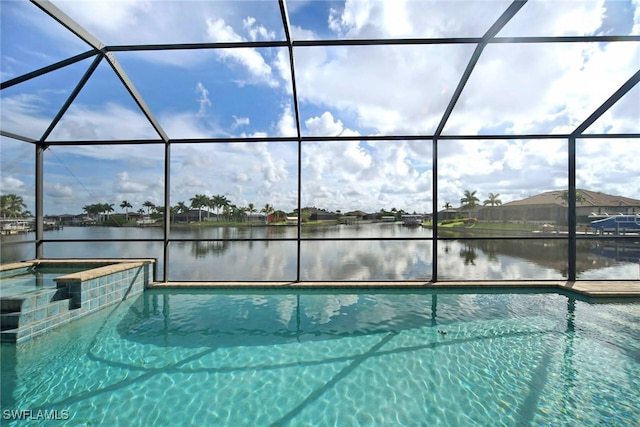 view of swimming pool with a water view and a lanai